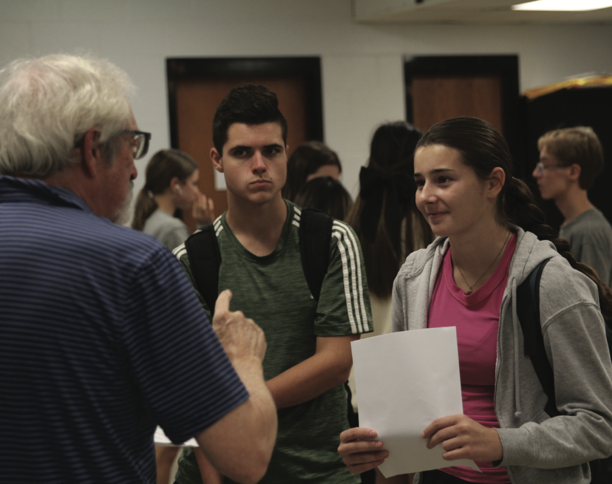 Juniors Carter Houdeshell and Sophia Arnold talk to Speech & Debate coach Randy Pierce on Mock Trial during a meeting that took place on Nov. 8. 